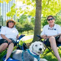 Jeff and Becky Eckstrom sitting in lawn chairs with dog